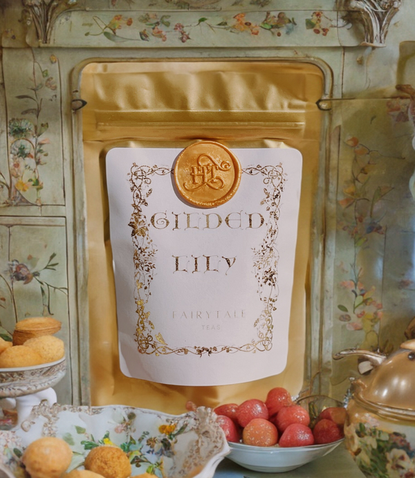 Bag of Gilded Lily sitting on a fairy's kitchen counter with fruit in decorative dishes and floral painted walls